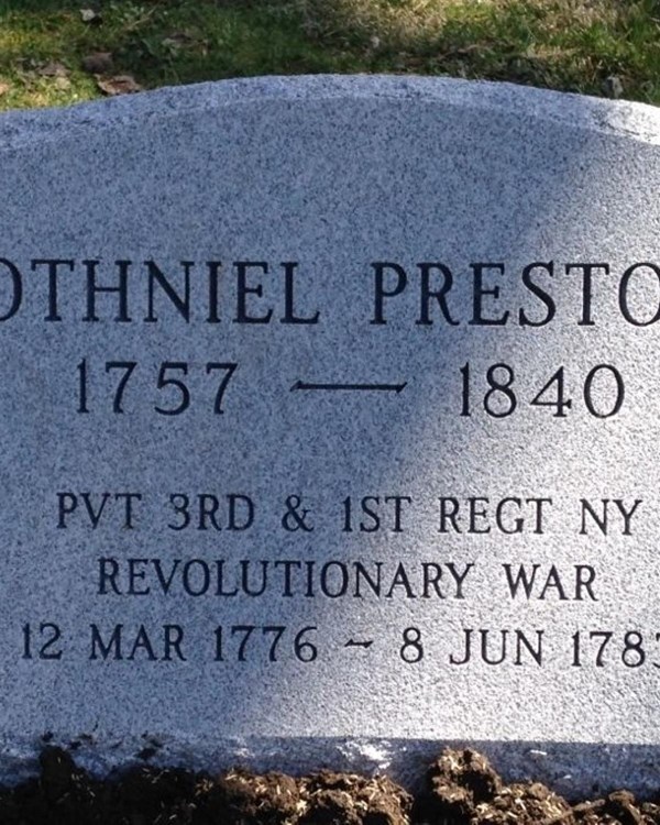 A granite headstone with the name "Othniel Preston" engraved on it.