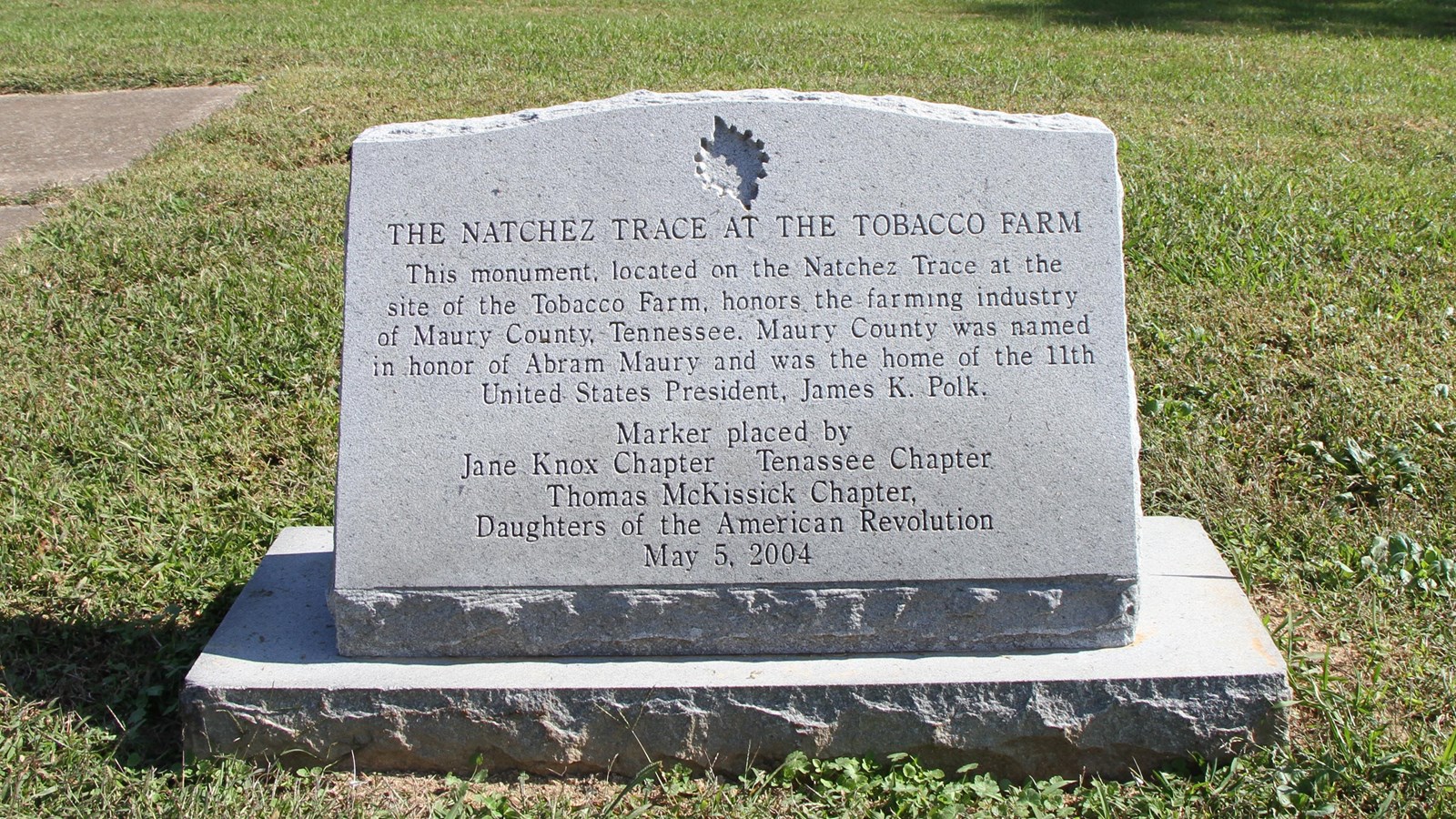 Granite monument about 3 feet tall with black wording etched on front honoring Maury County TN