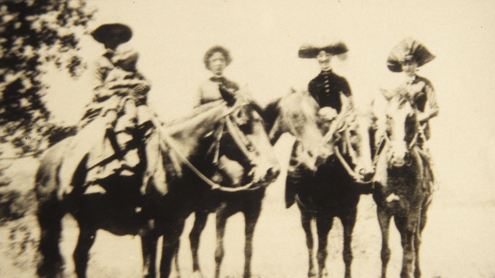 Four women on horseback and one child