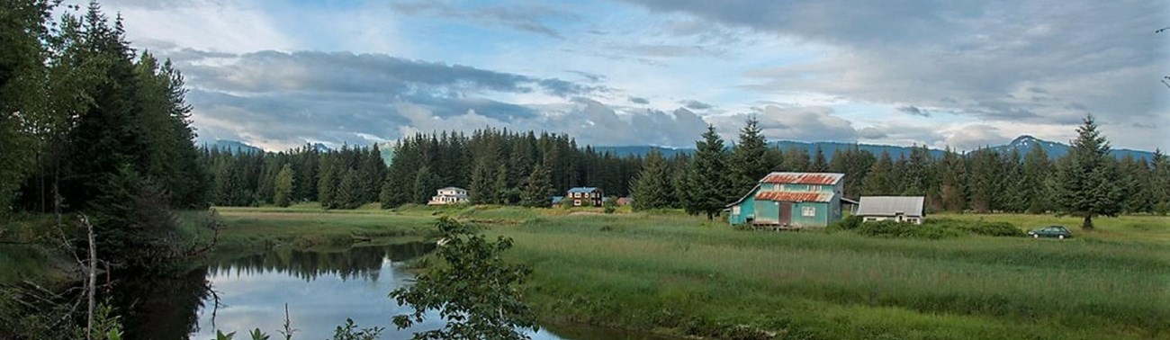 houses along a grassy riverbank