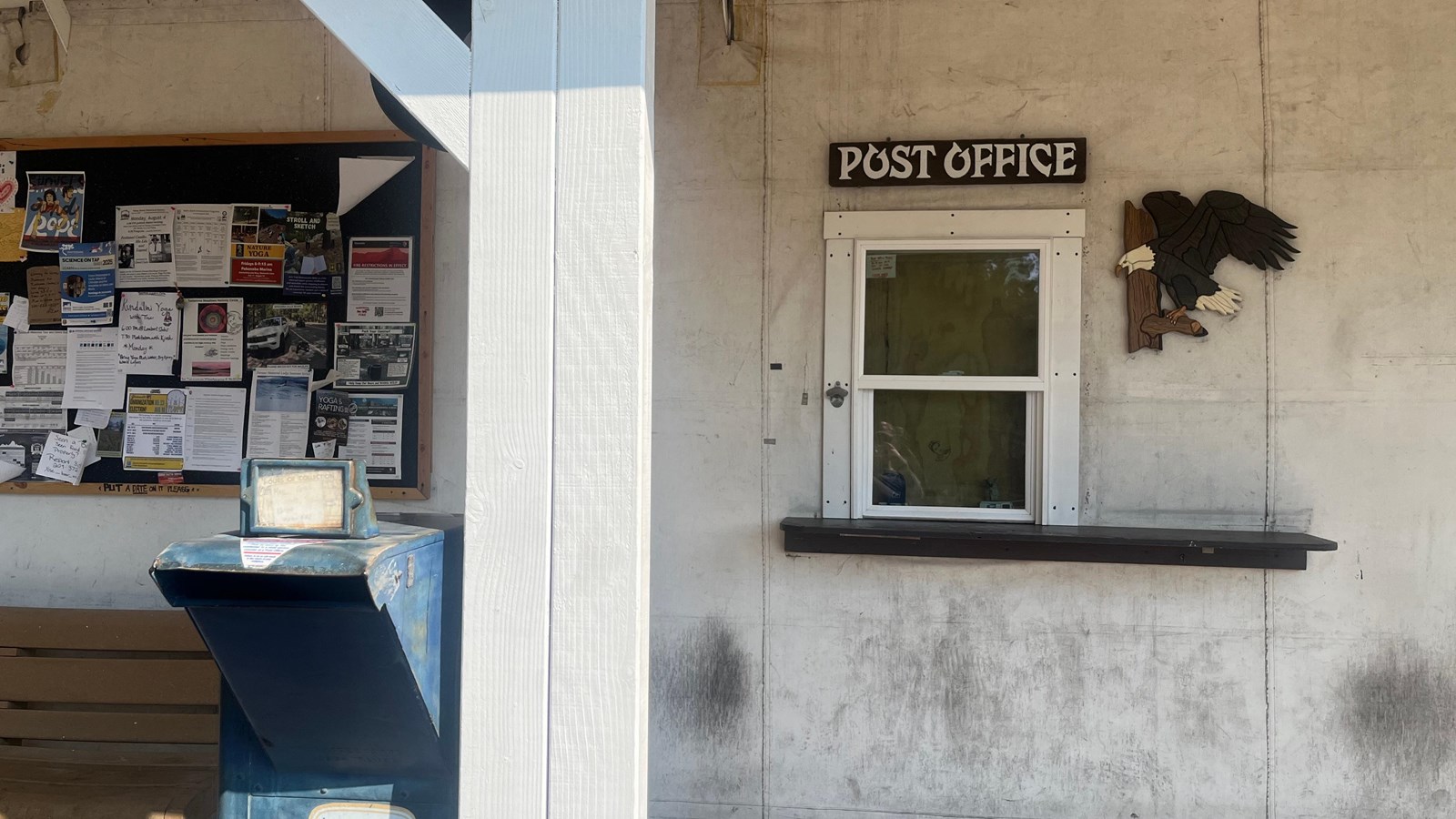 A white building with a walk-up window signed