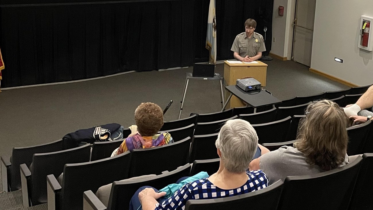 A park ranger presents a program in the auditorium.