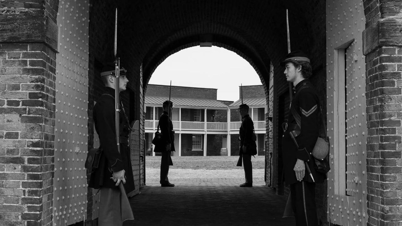 Living history volunteers standing sentry in Civil War uniform at sally port