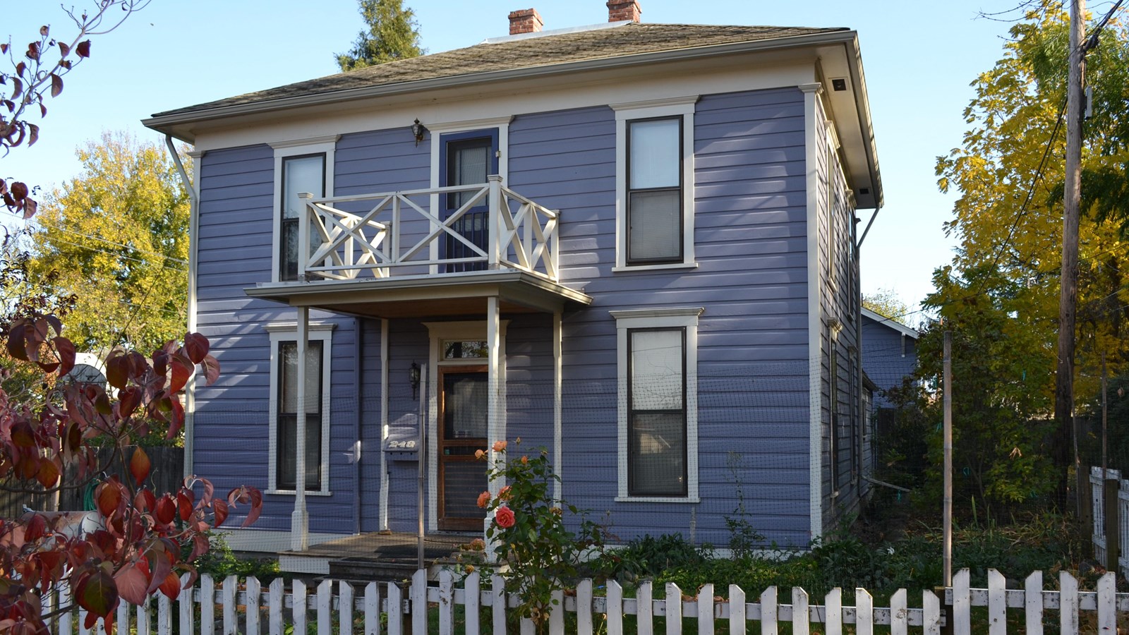 Two story blue house. 