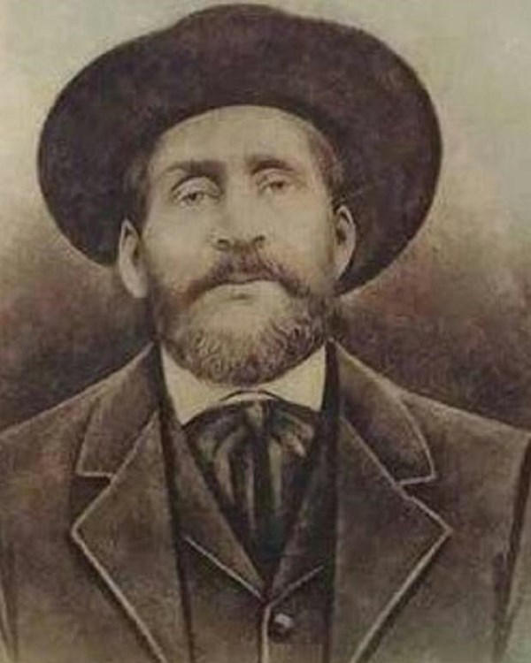 portrait of a bearded man in a suit and hat