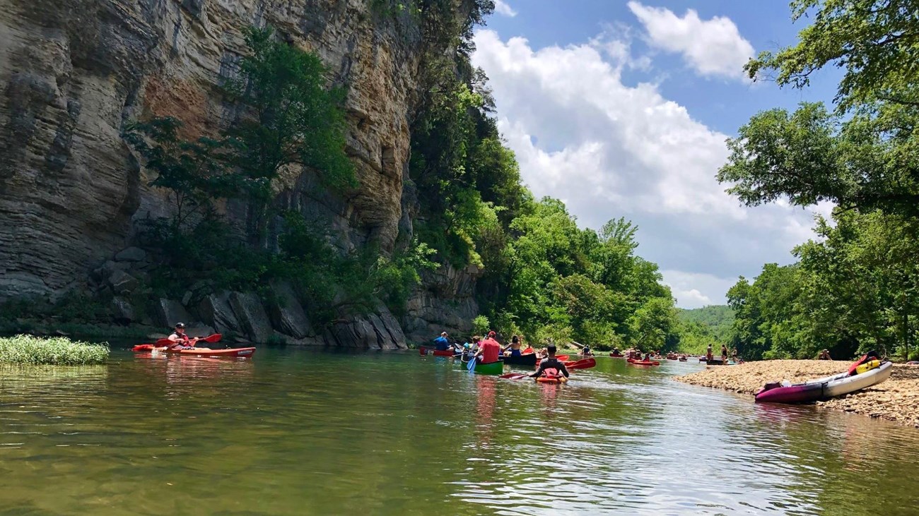 Many visitors paddle down the river.