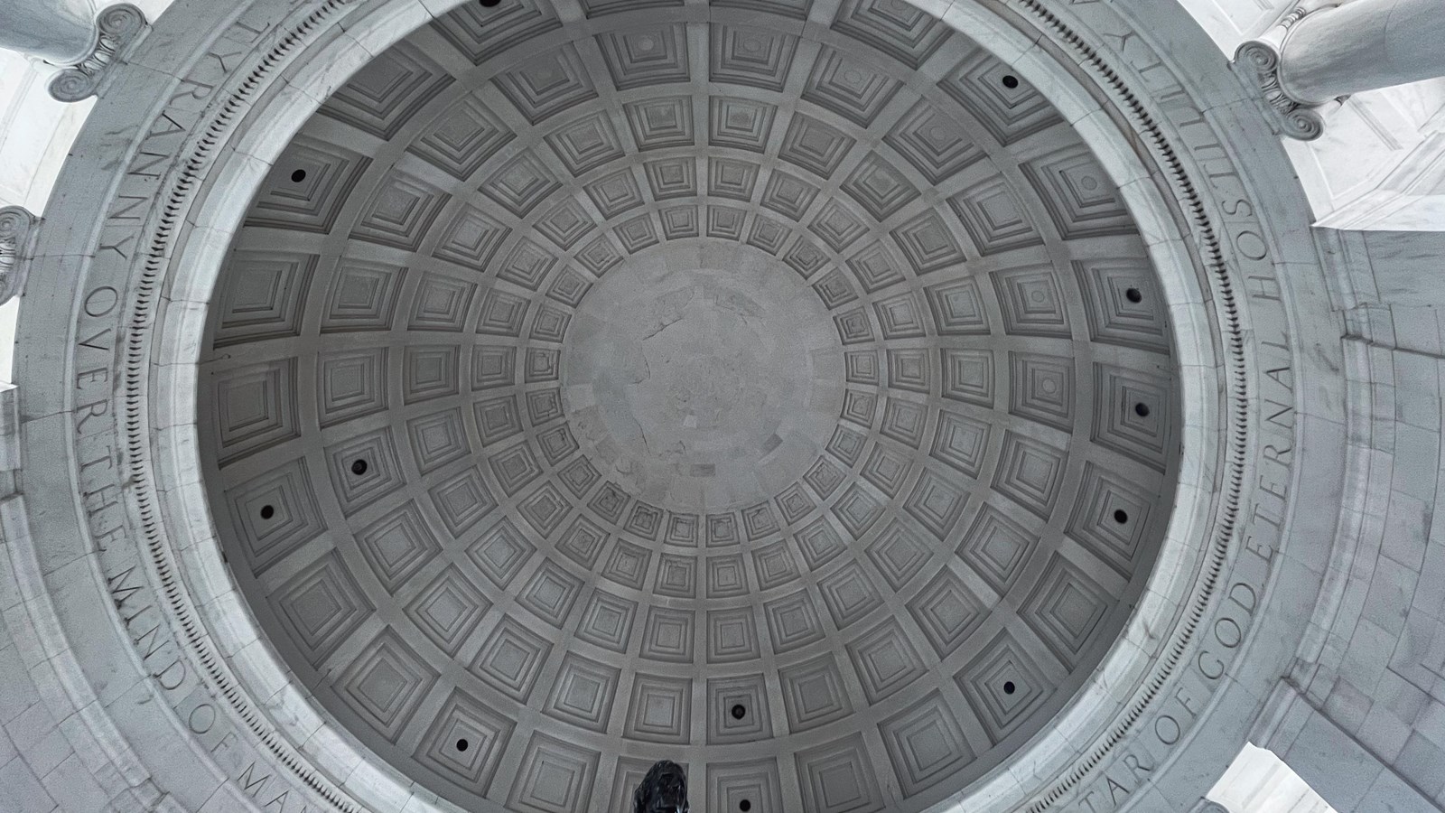 Rounded stone ceiling with letters carved around the interior rim