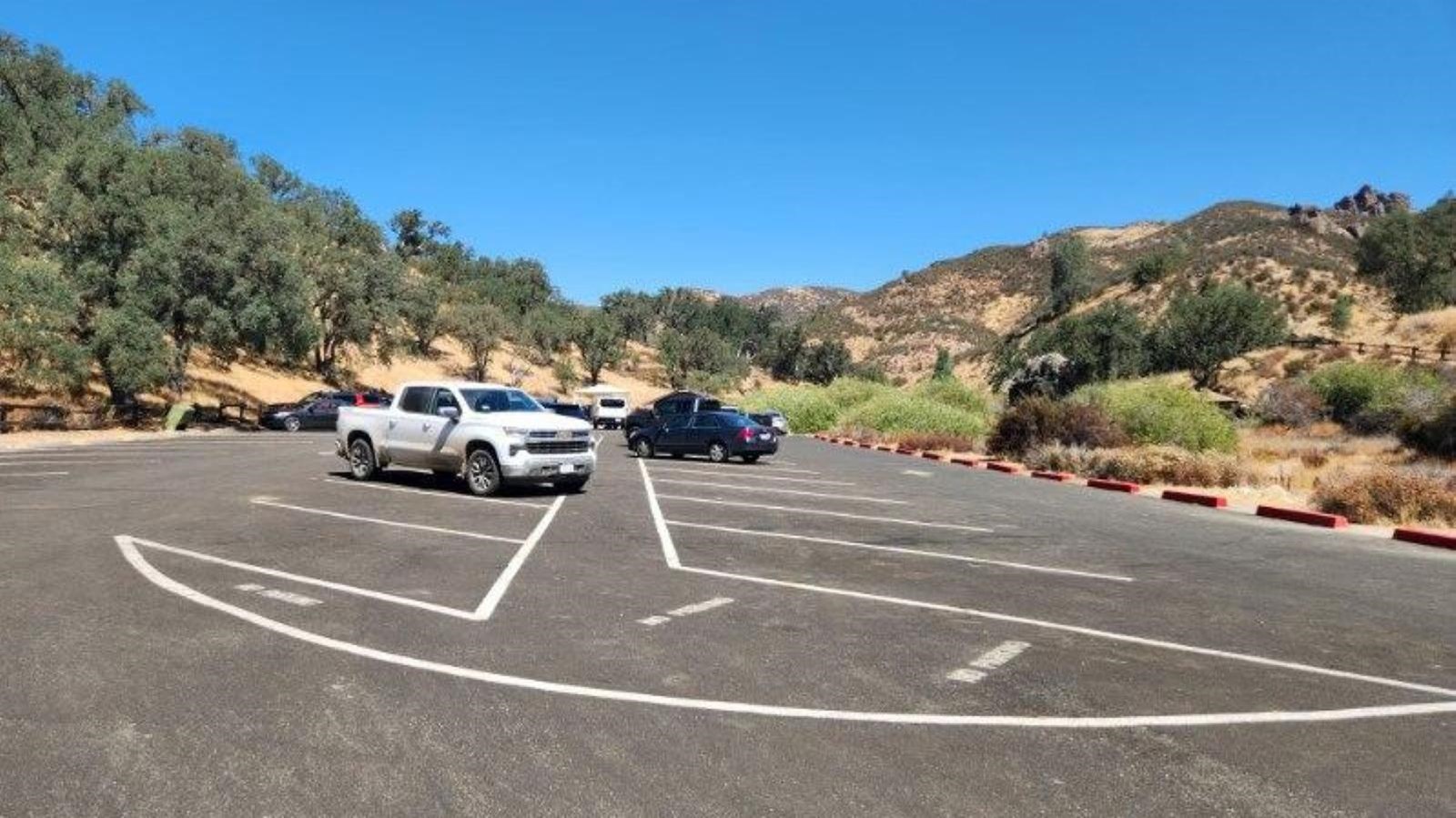 Gravel parking area surrounded by chaparral covered hillsides