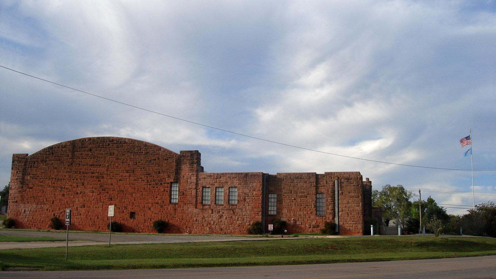 A large red brick building with an arched roof.