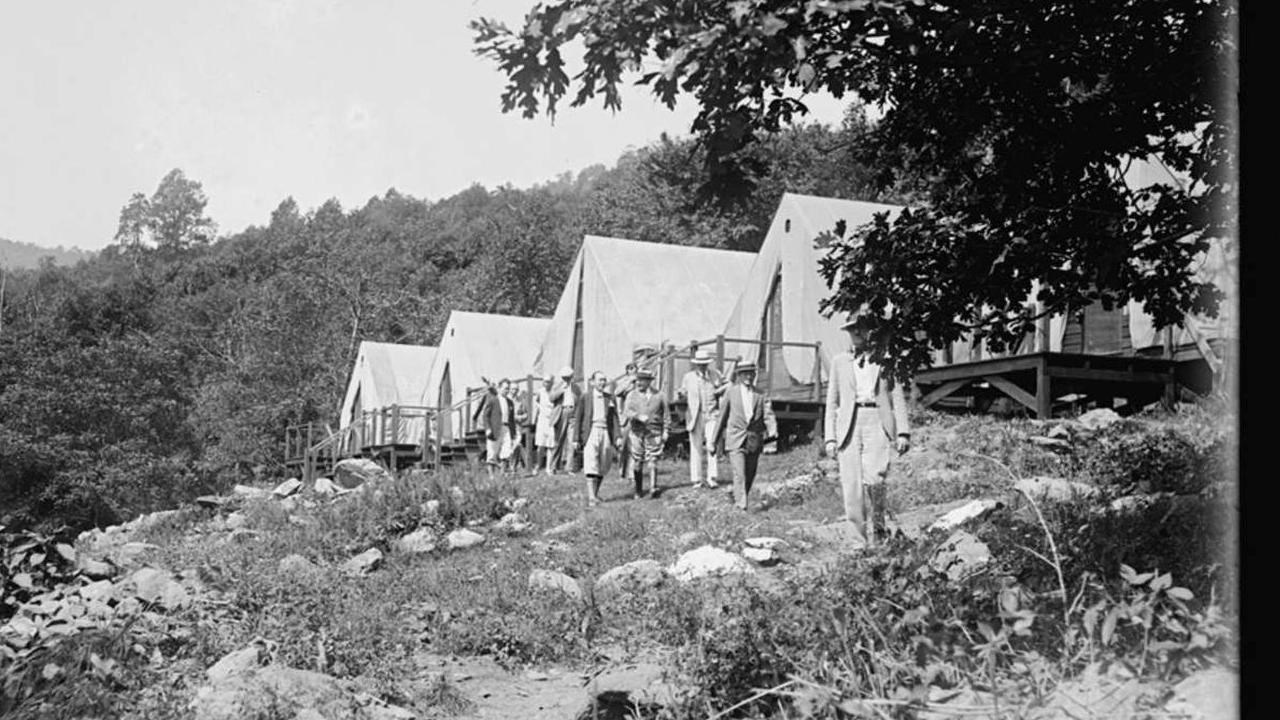 Several large white tents in a row.