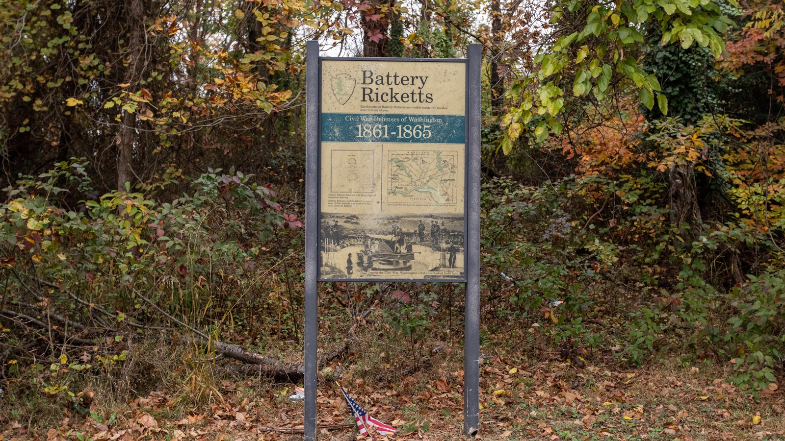 An informational panel in front of a forest. 