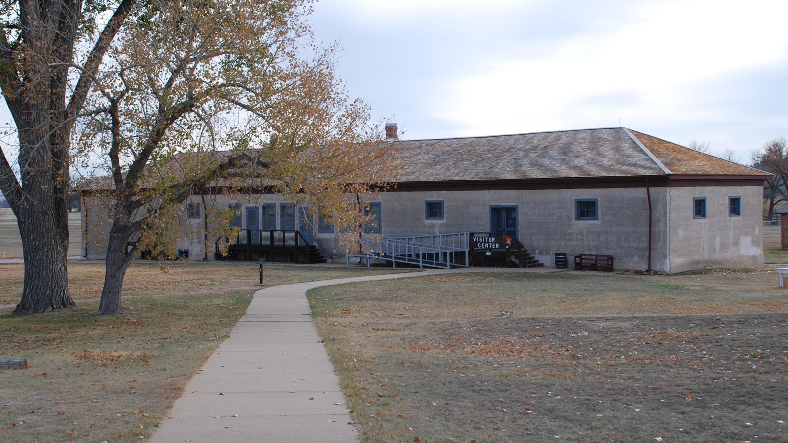 The post commissary storehouse at the end of the concrete path from the parking lot.