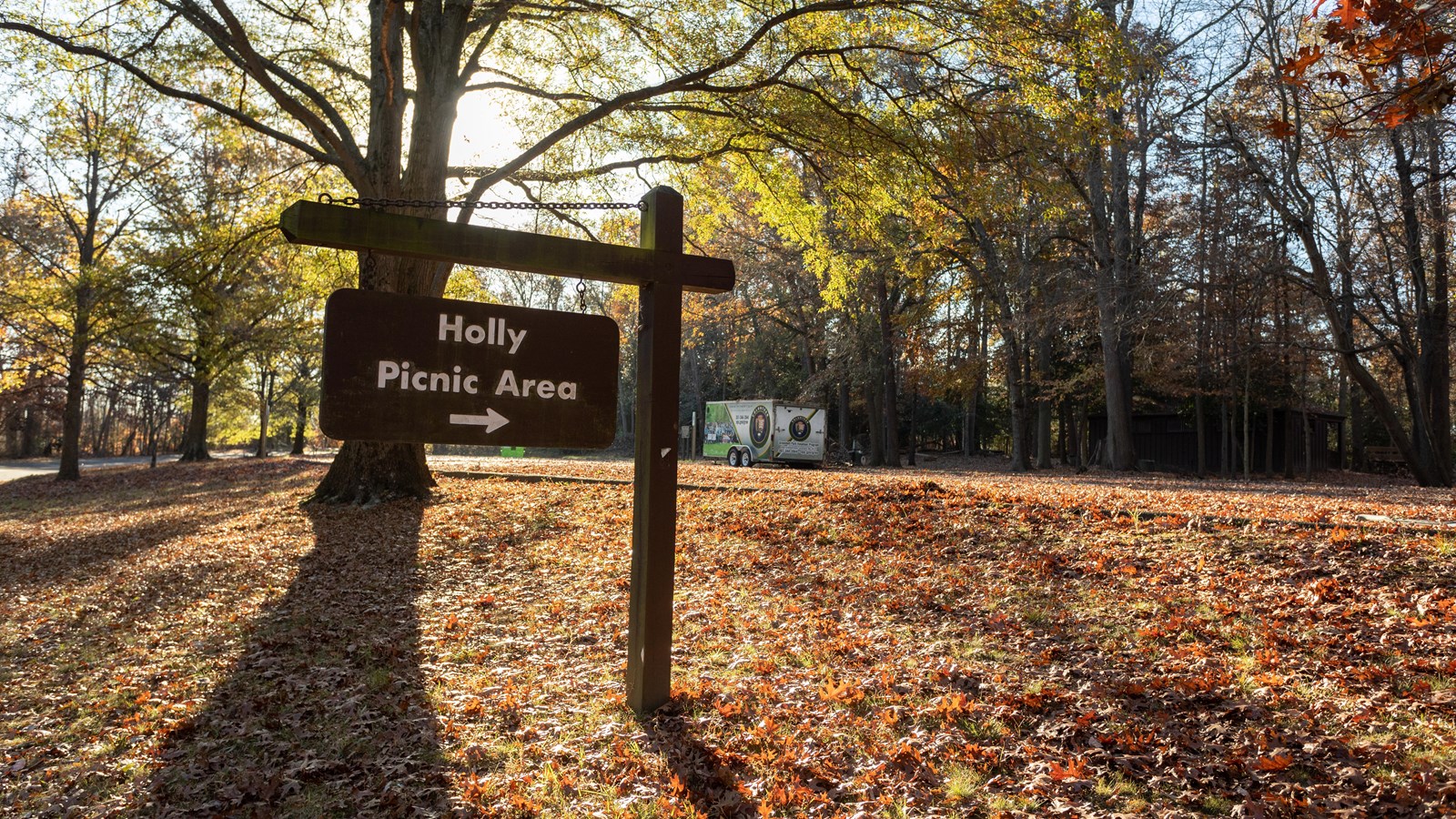 A sign in front of a wooded picnic area