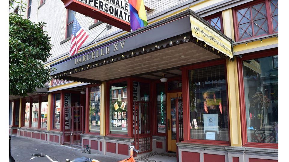 Old storefront with the name of the site above the door and ‘X’ patterned windows