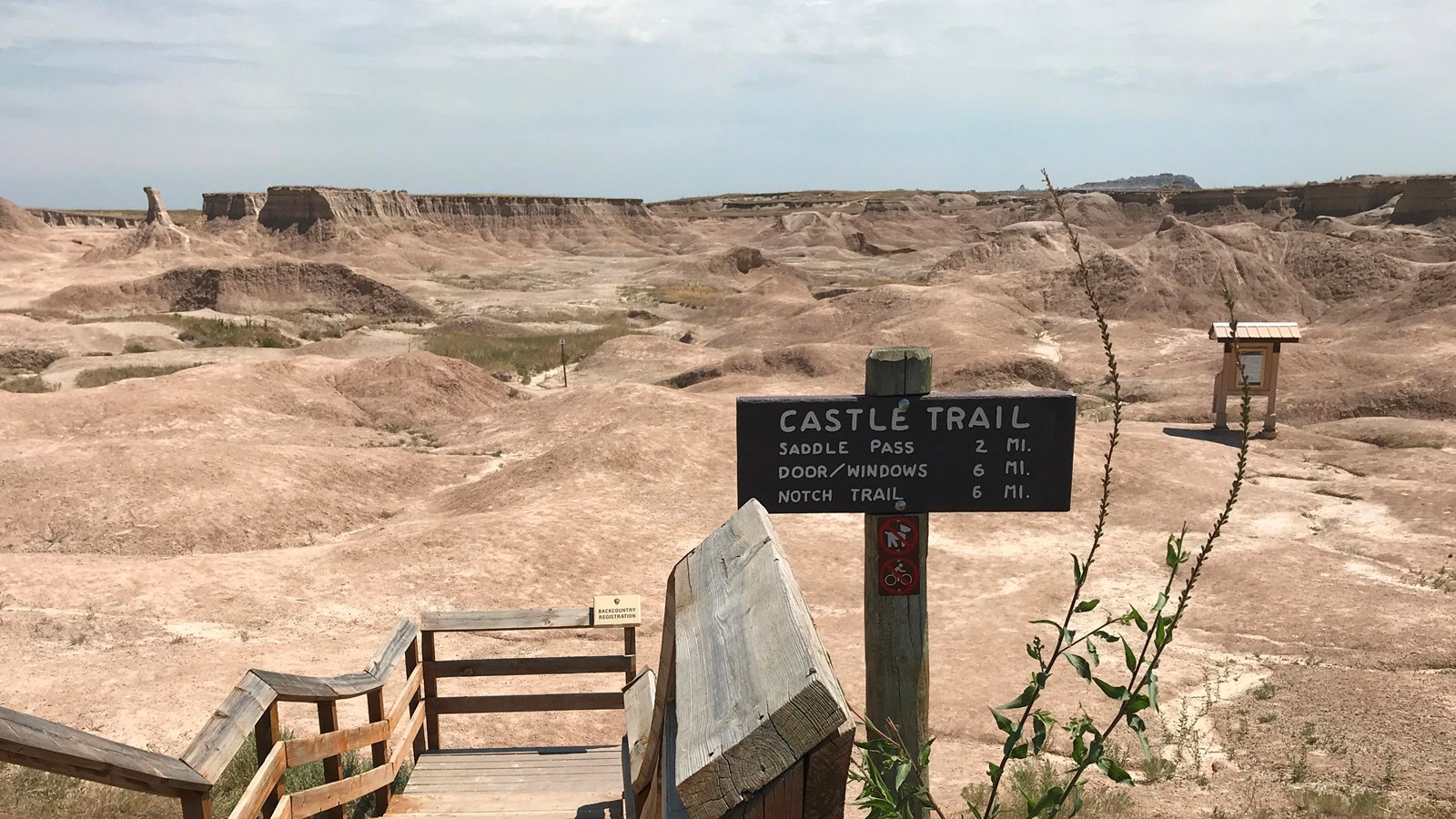 Wooden boardwalk gives way to rolling badlands formations and a meandering trail.