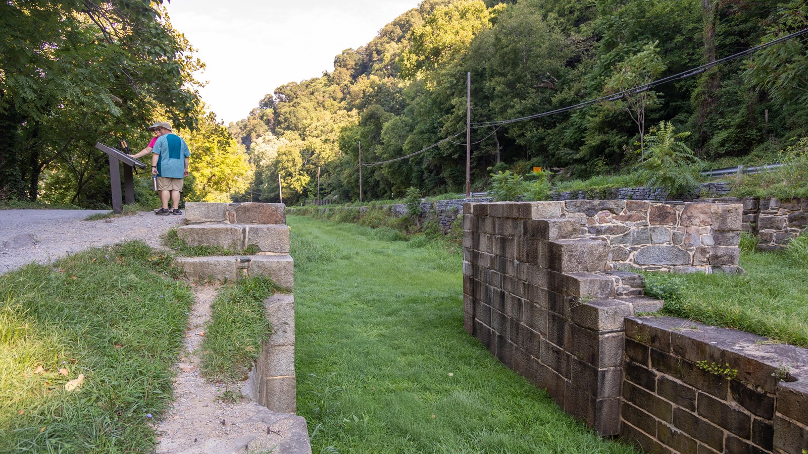 An old stone structure on the right of a trail