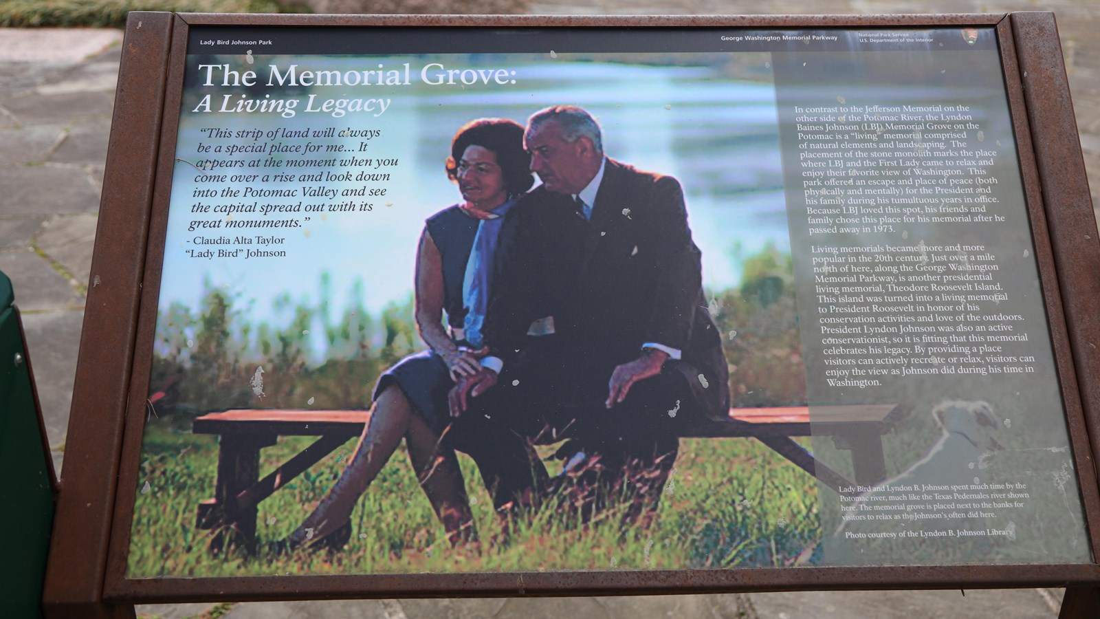 An information panel with text and a photo of President Johnson and his wife sitting on a bench.