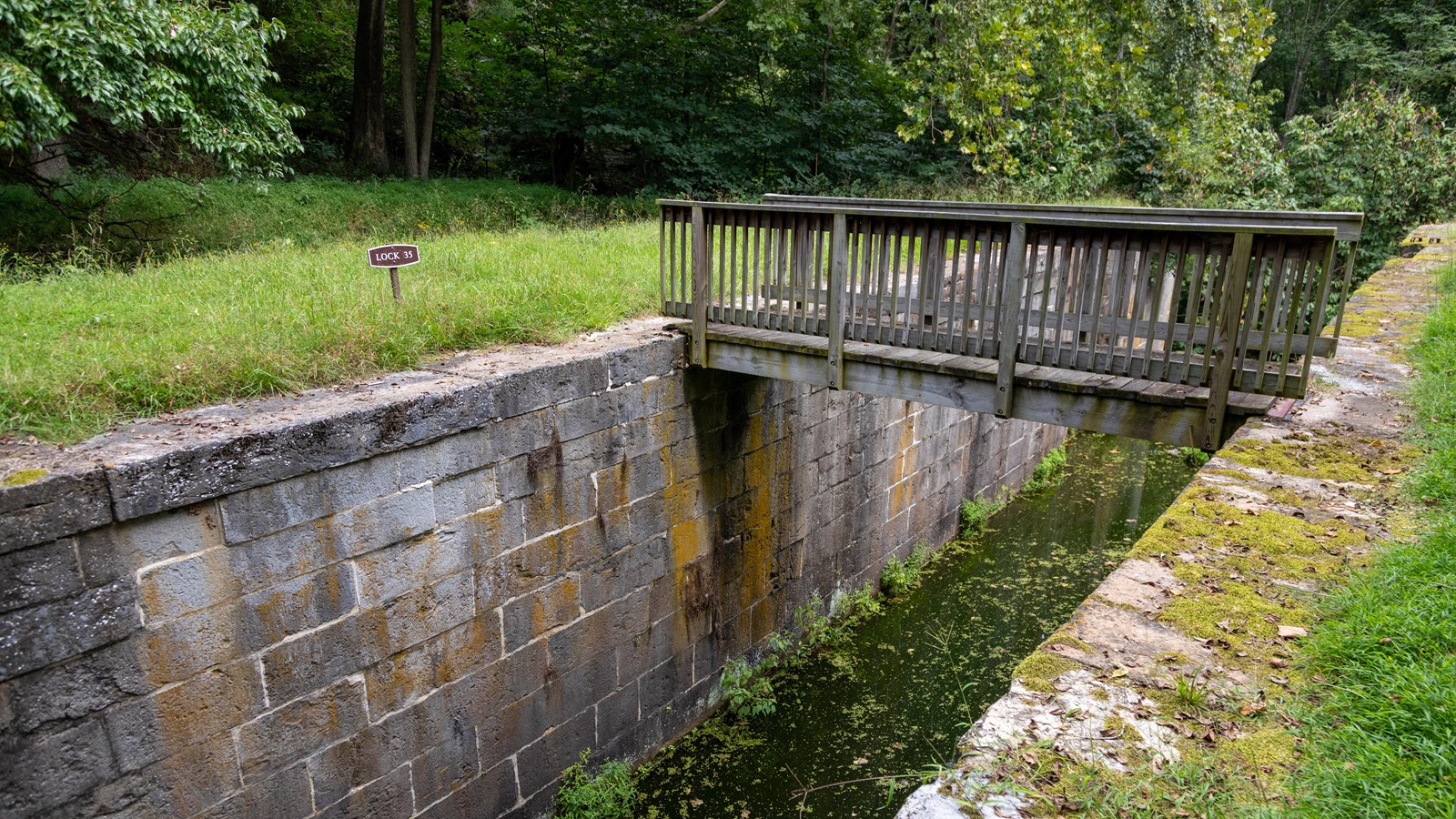 A stone structure with a bridge connecting two areas.