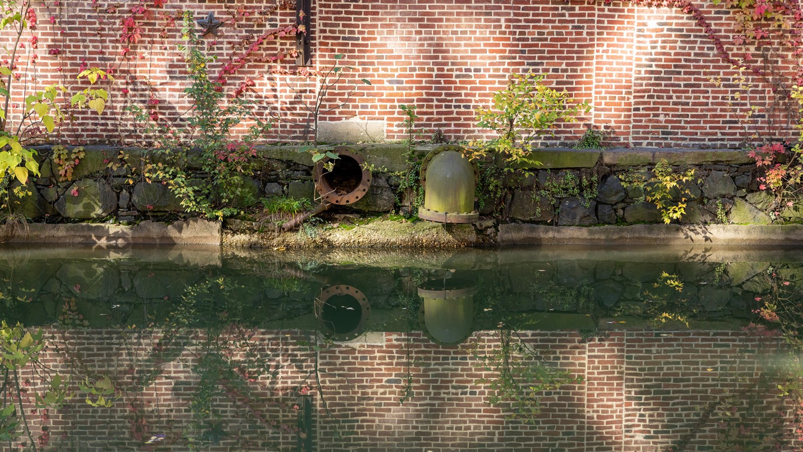 A building next to a reflective stream of water