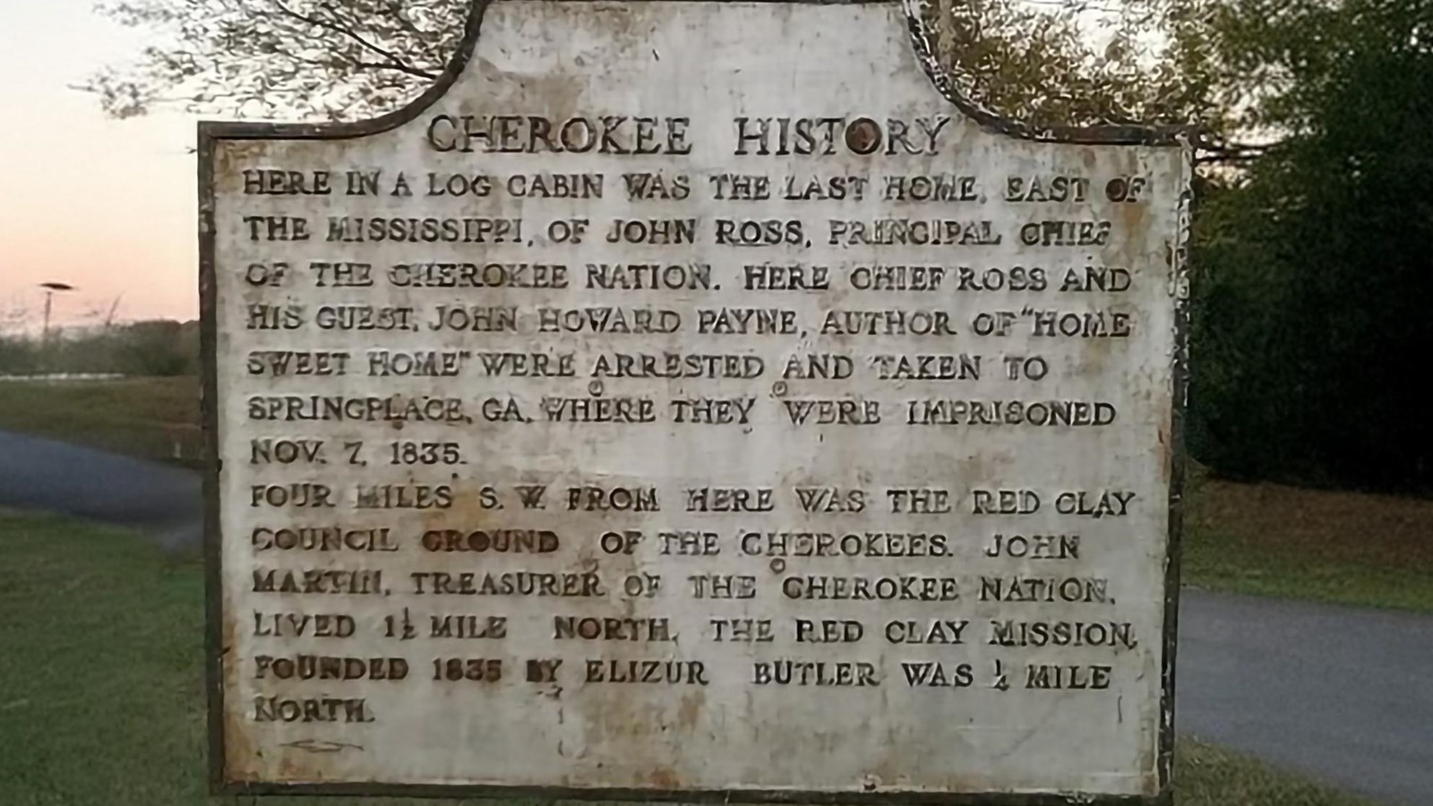 A white historic marker with text identifying the site of John Ross\'s farm.