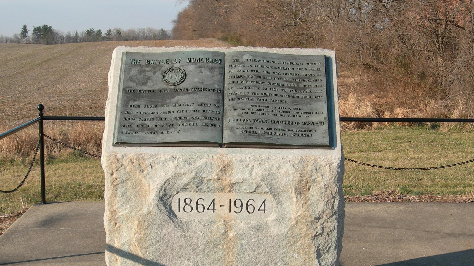 A stone block with a bronze tablet that looks like an open book on top.