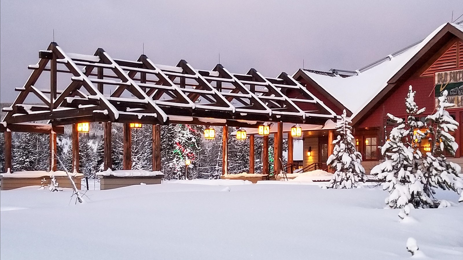 A large red lodge in a snowy landscape.