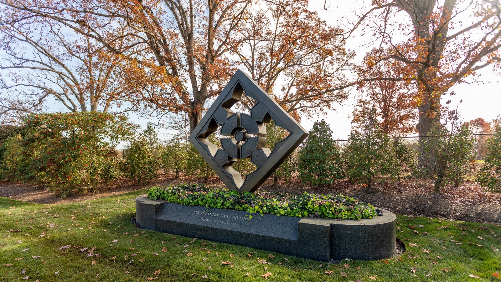A diamond art piece surrounded by greenery. 