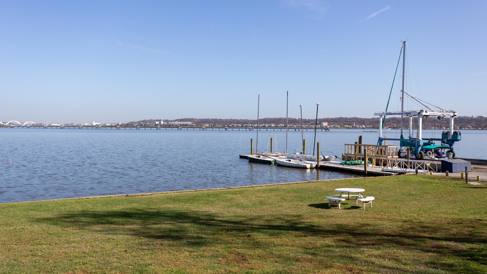 A ship next to the shoreline of a river. 