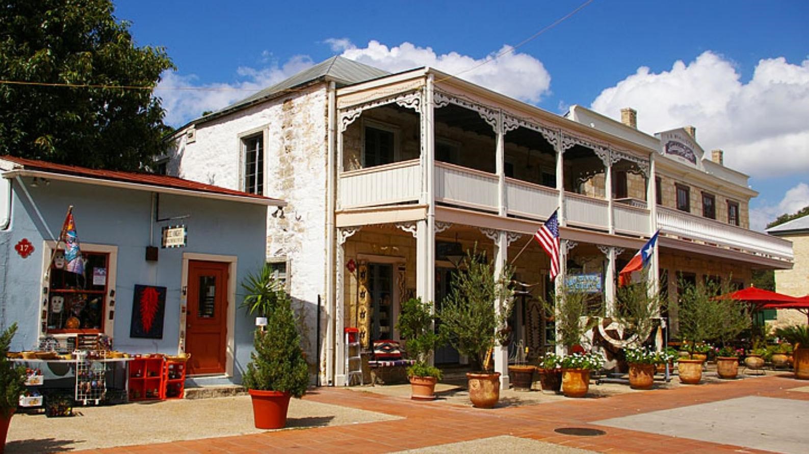 A two story building with covered balcony in a historic district 