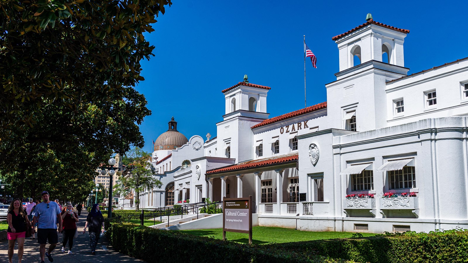 White stucco building with Spanish-style architecture. Two large towers stand out against a blue sky