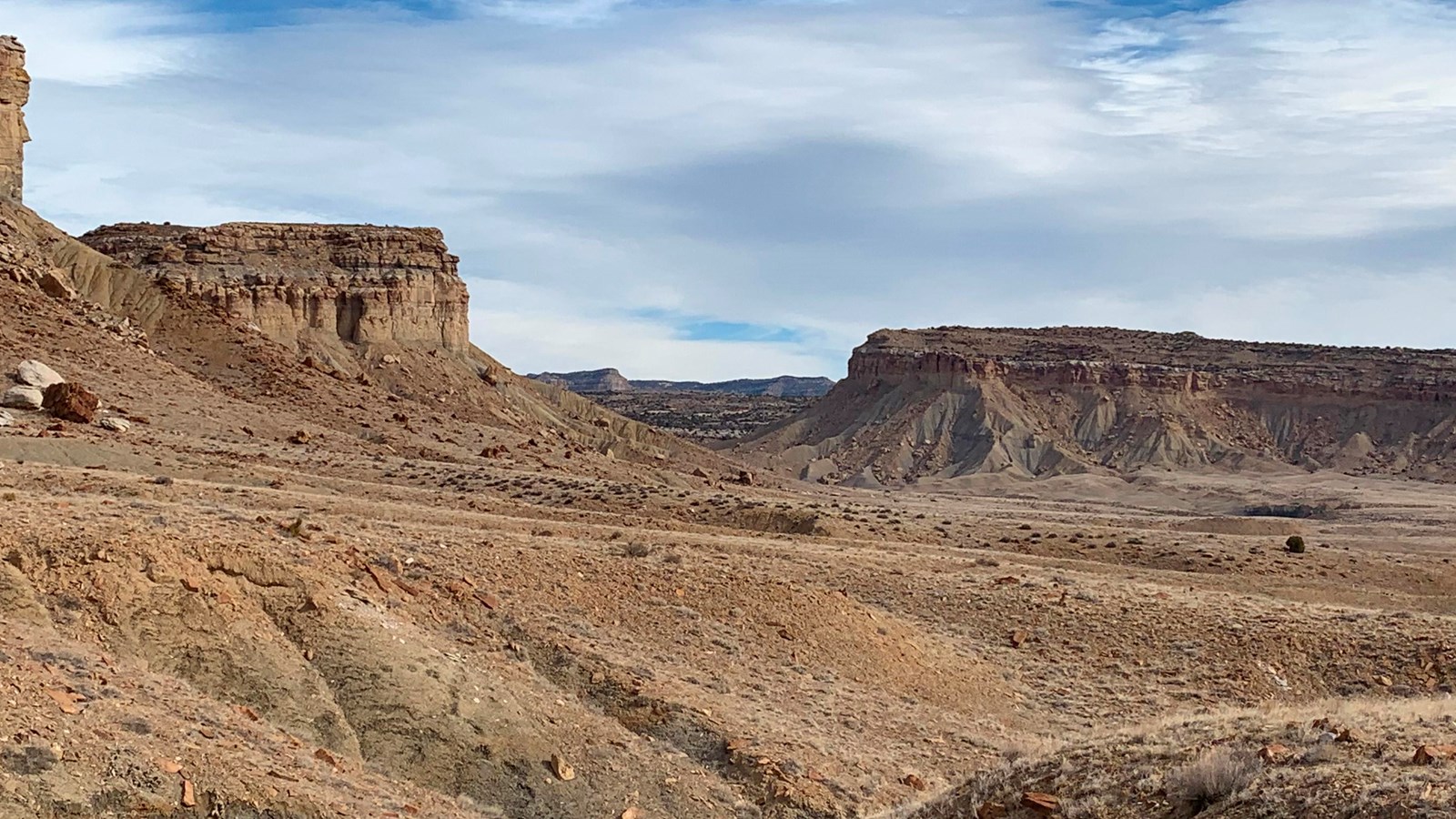 An open, barren desert area extending into a gap.