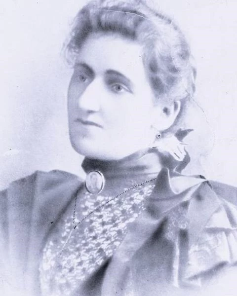 portrait of a black woman wearing a high-collar blouse.