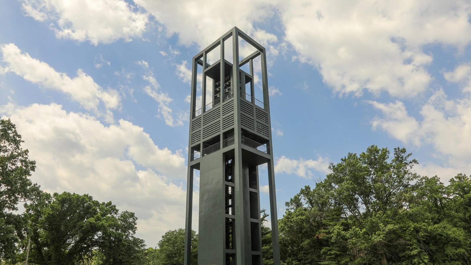 A tall bell tower against a cloudy sky
