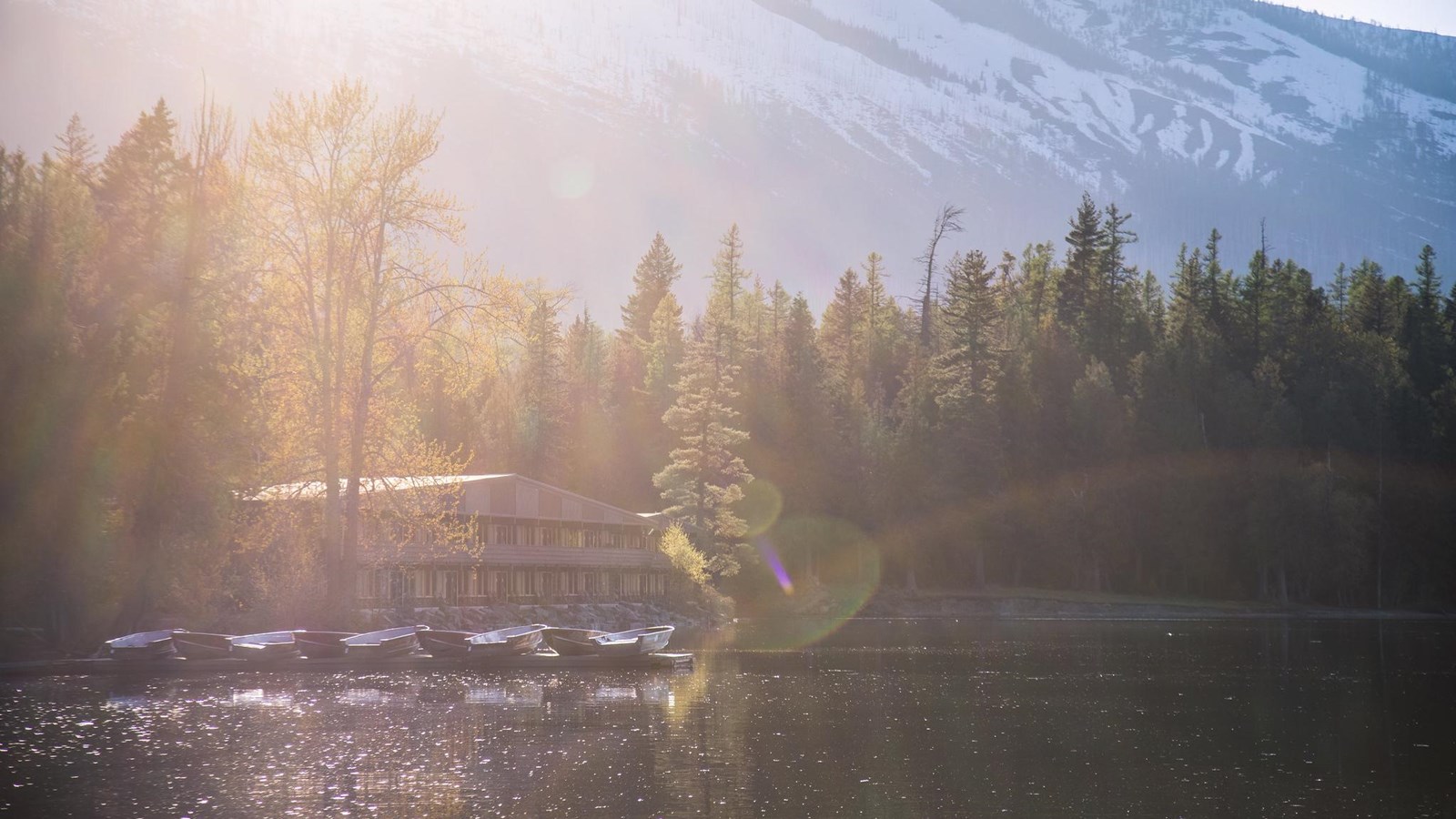 The apgar village inn and boats docked on lake mcdonald.