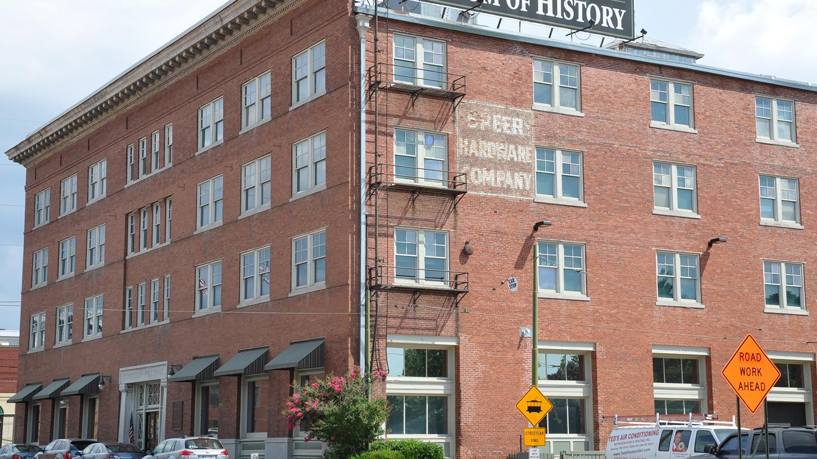 Four story red brick building with a large sign on the rood that reads Fort Smith Museum of History.