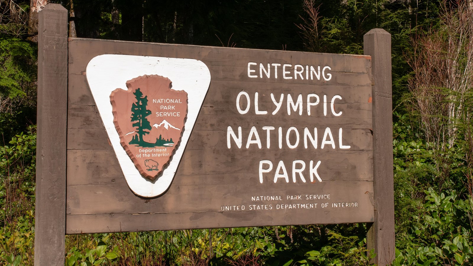 A brown wooden sign reads 