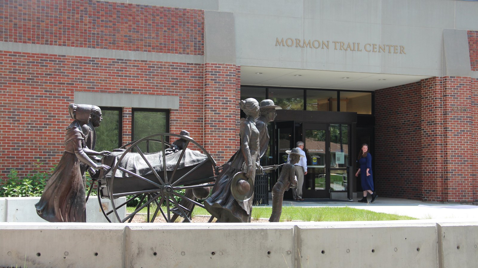 Pioneer statues sit in front of the Mormon Trail Center.