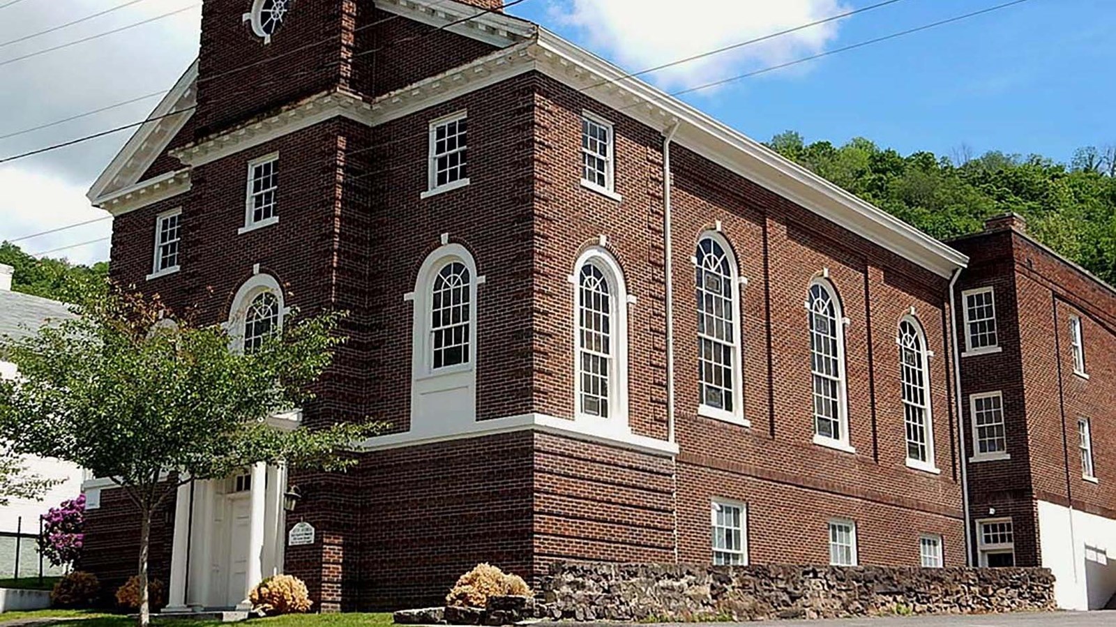 The front of a large, red bricked church