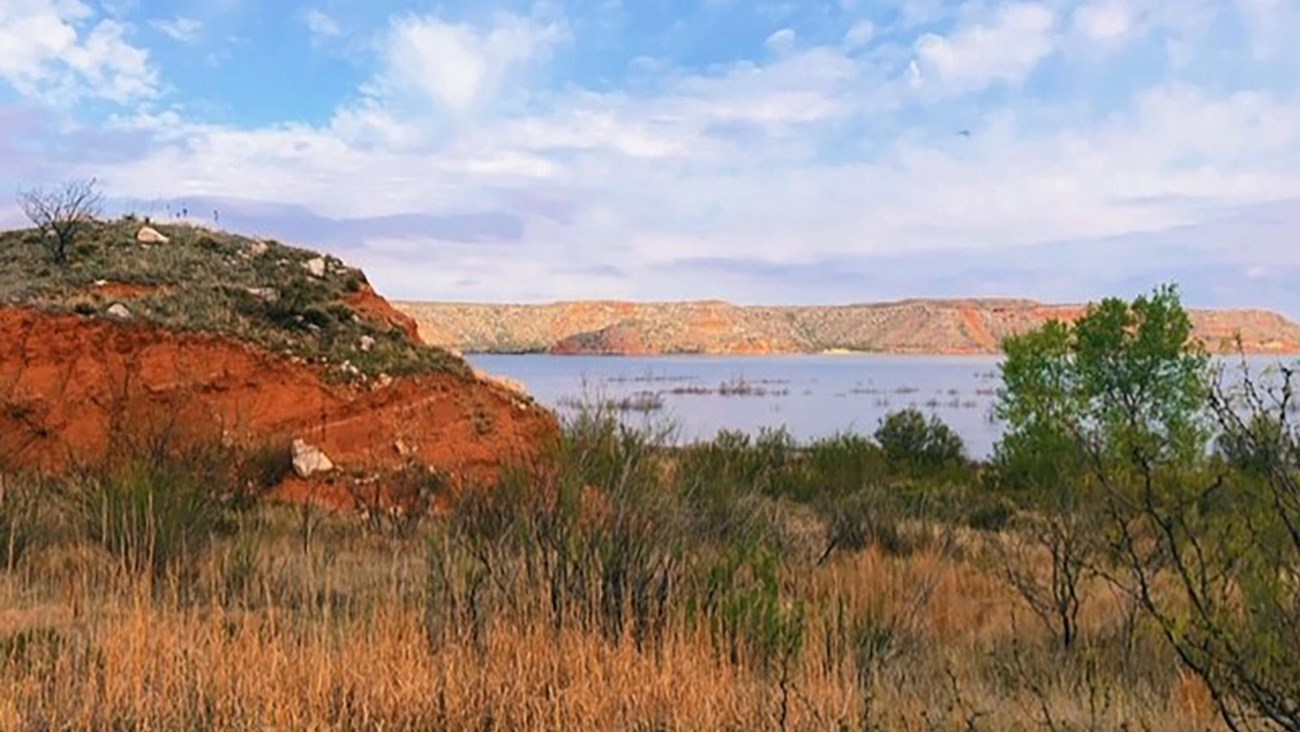 A view of Lake Meredith from the trail on a sunny day with blue skies.