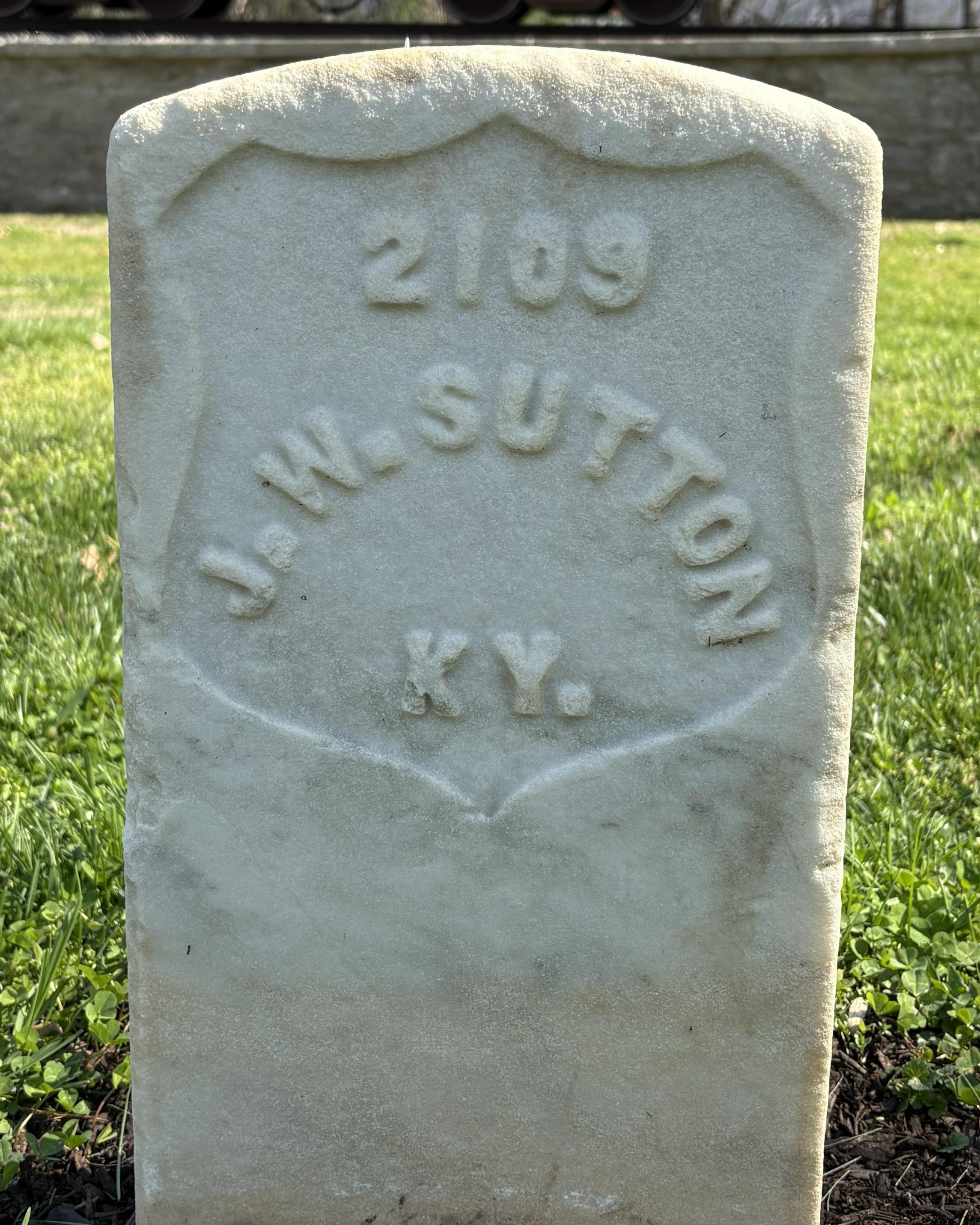 Marble headstone reading "J.W. SUTTON KY."