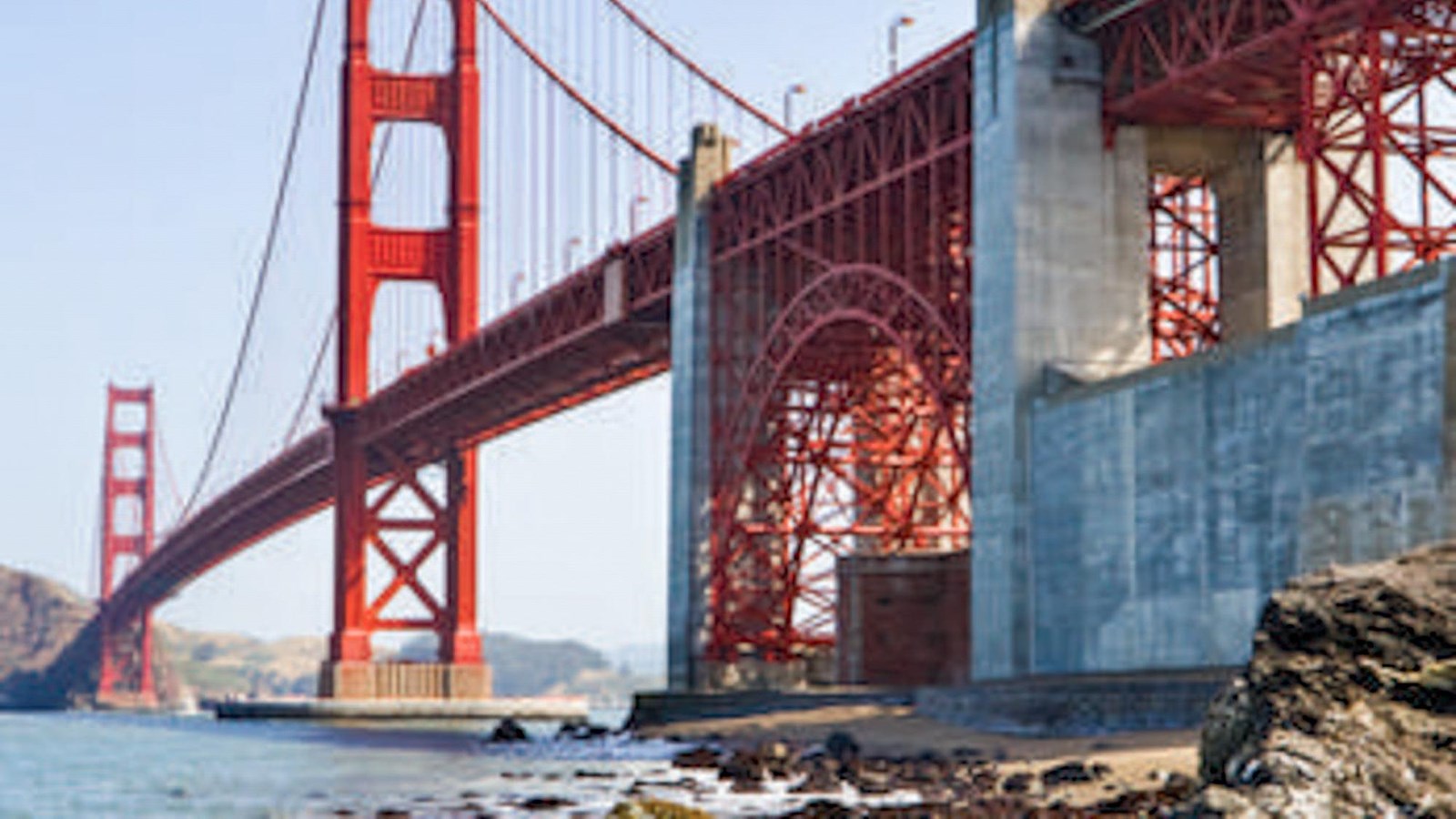 Colored photo of the bright color of the Golden Gate Bridge as seen from Fort Baker