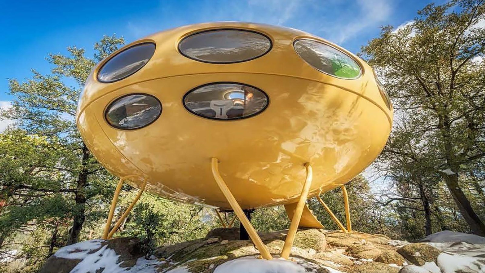 Looks like a yellow flying saucer landed in a snowy wooded area
