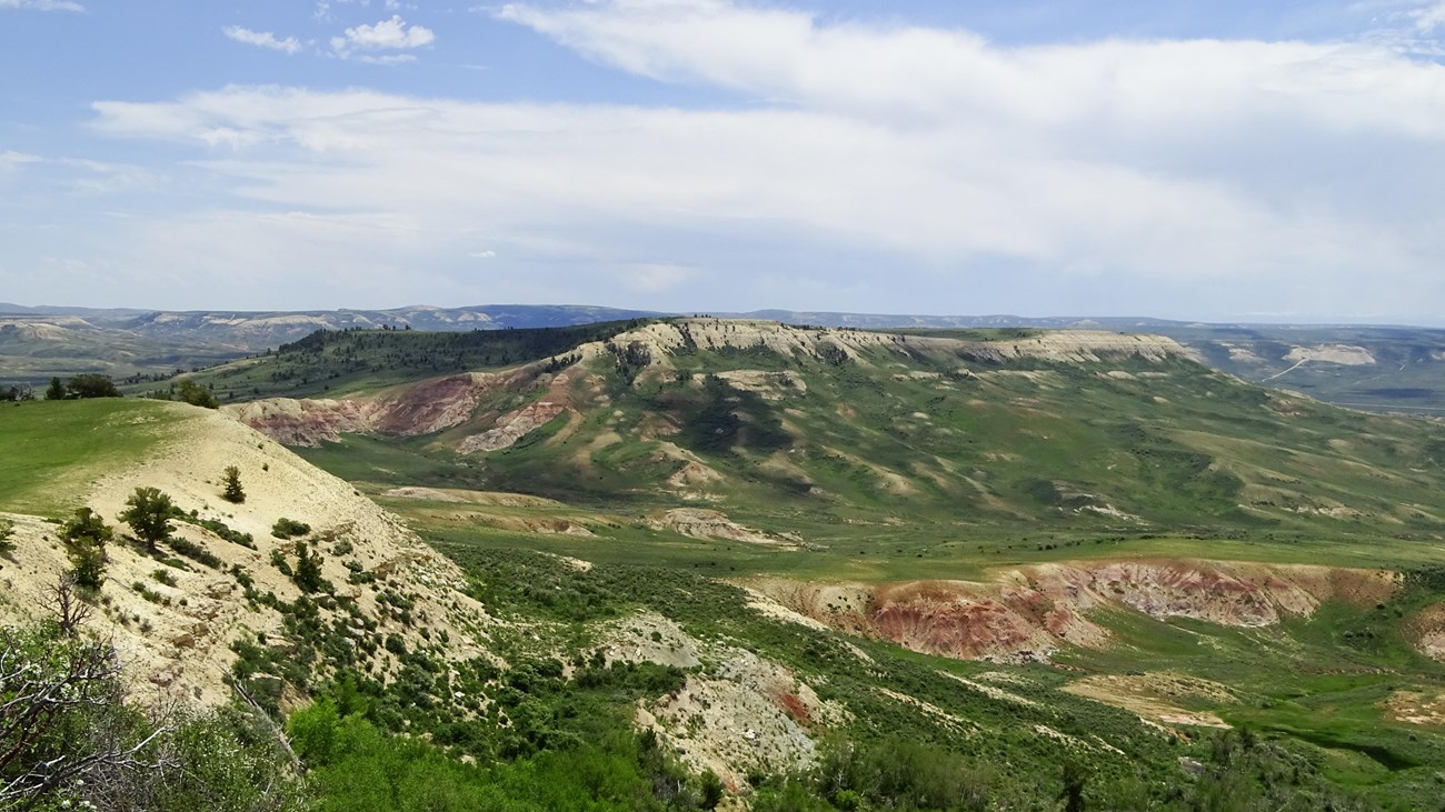 Profile of a ridge on the left looking across a valley to another ridge in the middle distance.