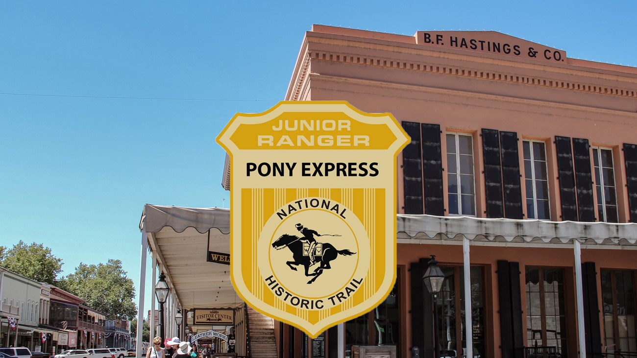 A junior ranger badge on the picture of a historic wooden building.