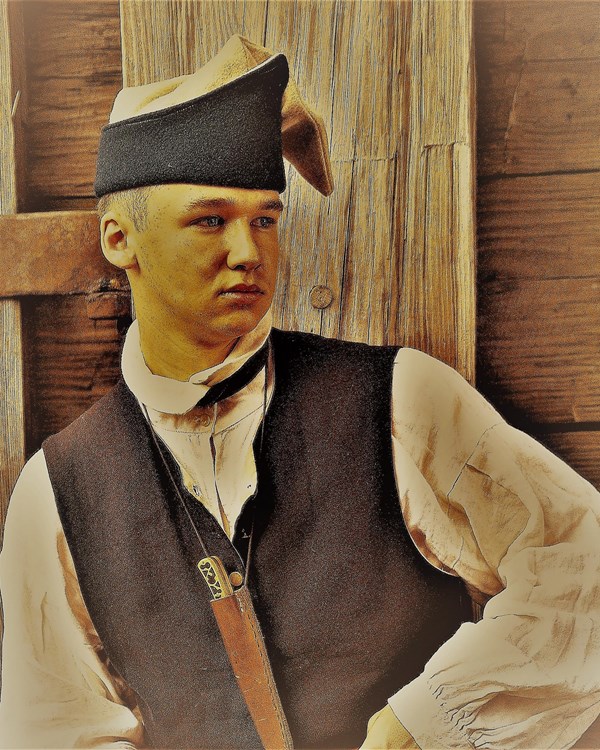 A young man in a Continental Soldier's small clothes stares off to his side and into the distance