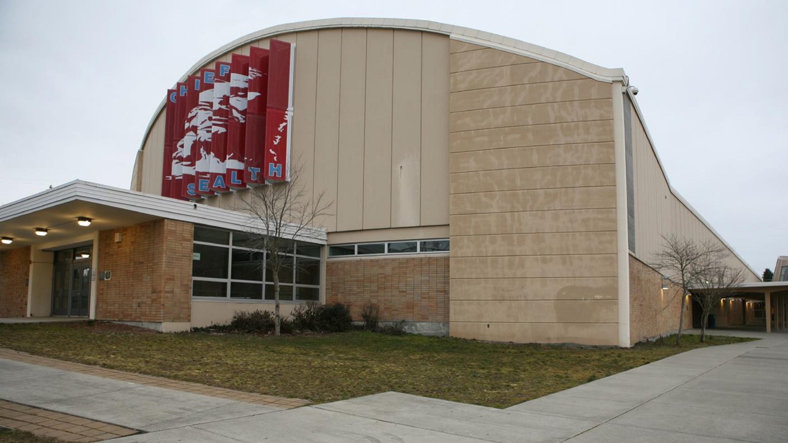 Tan-colored high school with red banner