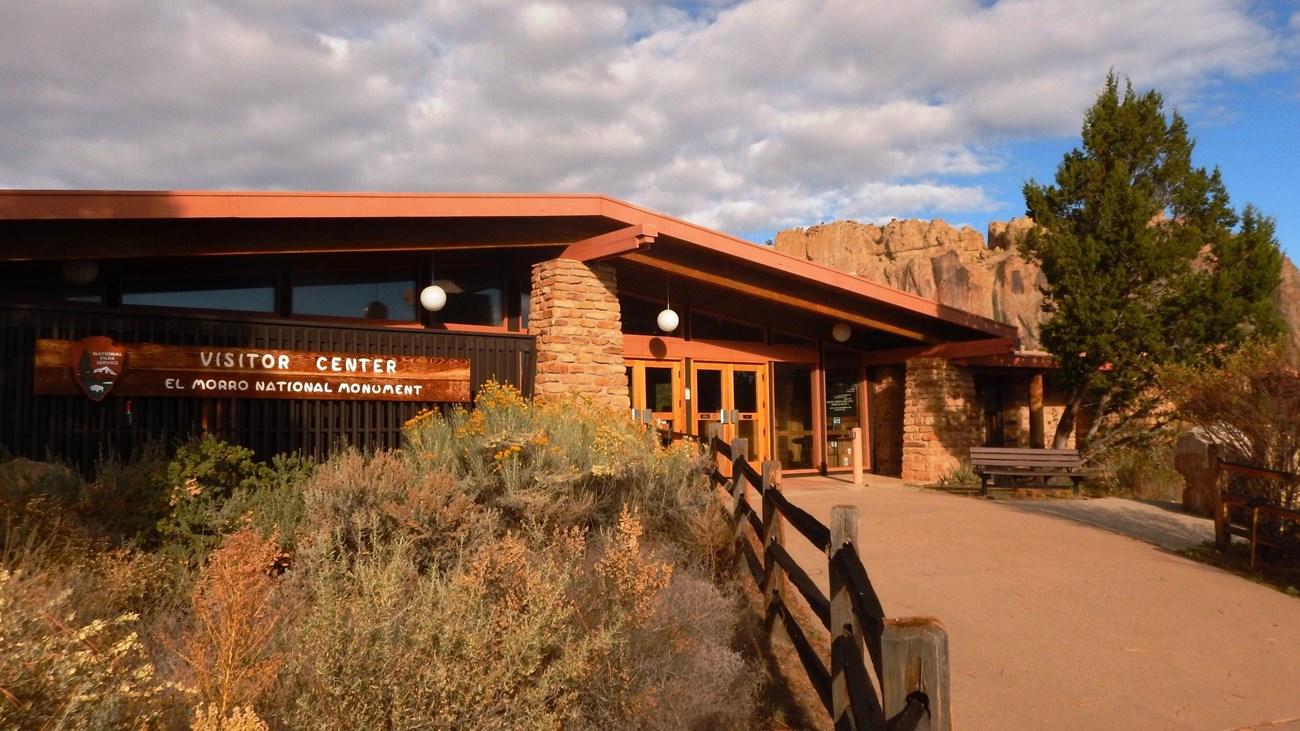 A building in front of a large cliff.