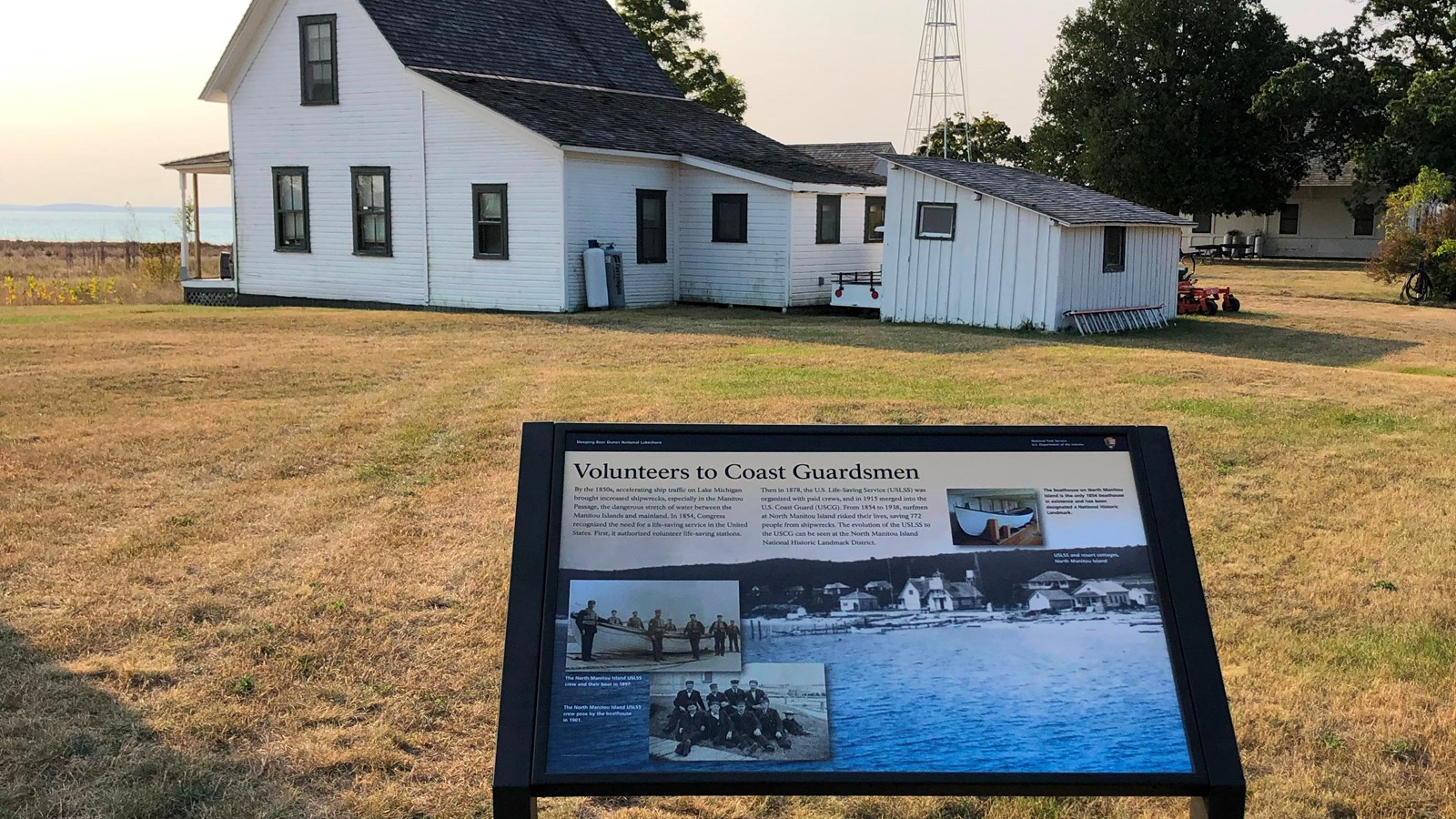 Sign in front of a white historic house on North Manitou Island