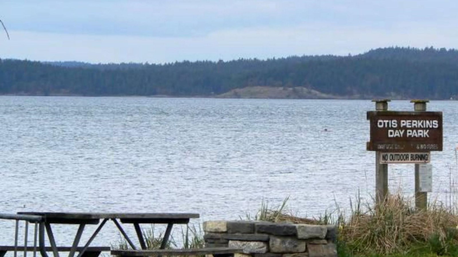 Photo of a picnic table and sign reading
