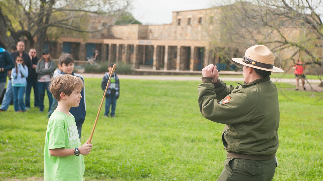 Park Ranger demonstrates using the atl atl at the Visitor Center